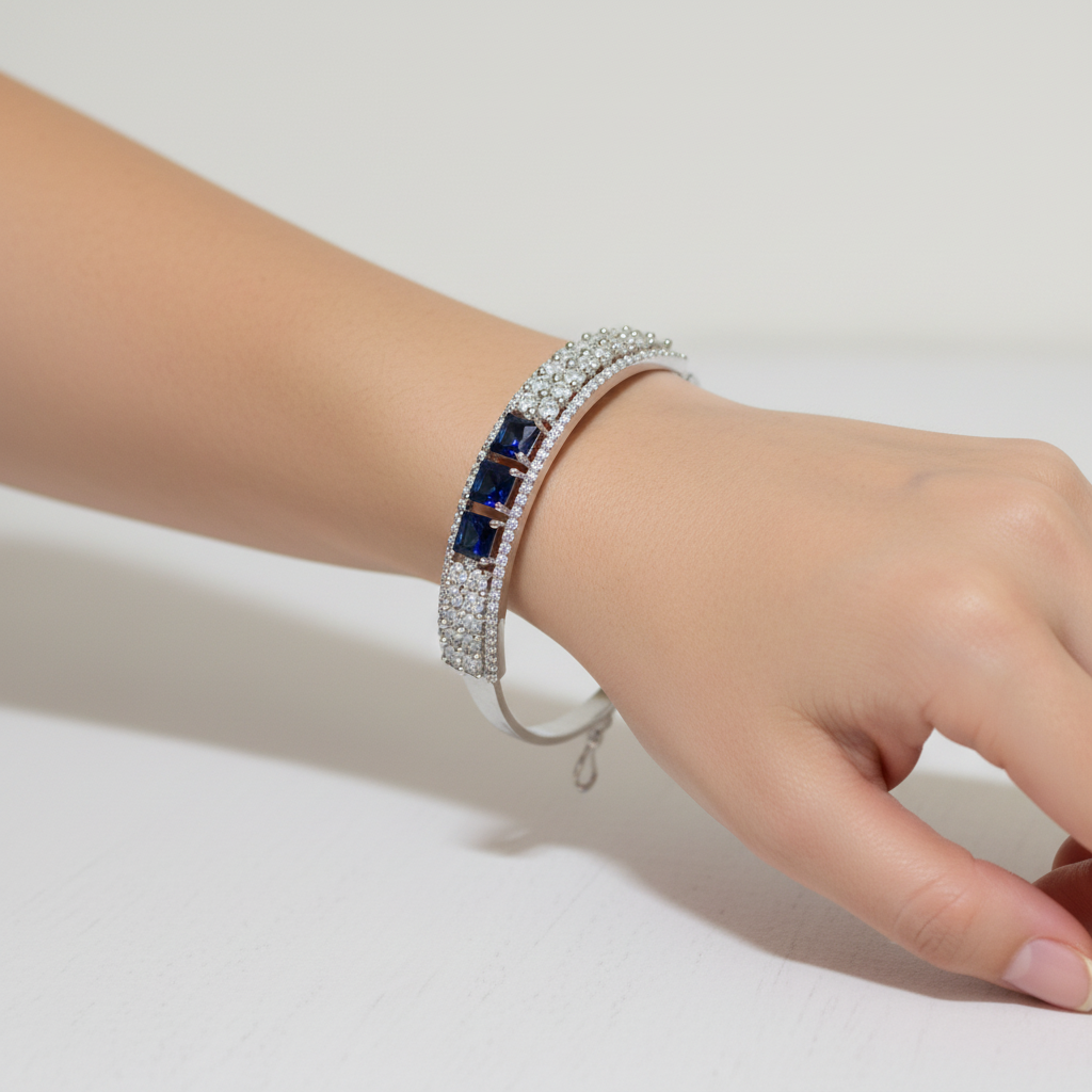 Model wearing blue sapphire bangle bracelet - close-up