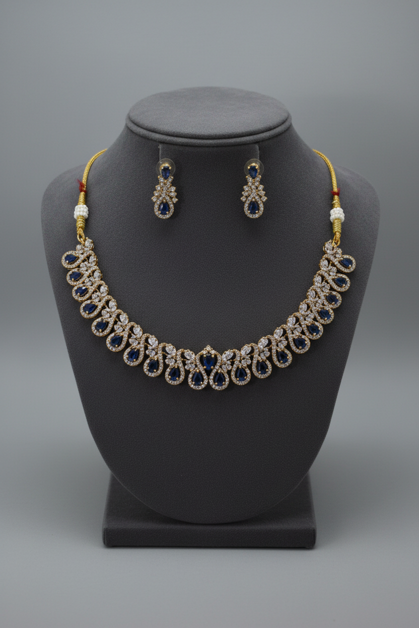 Blue sapphire and gold-tone jewellery set on display stand