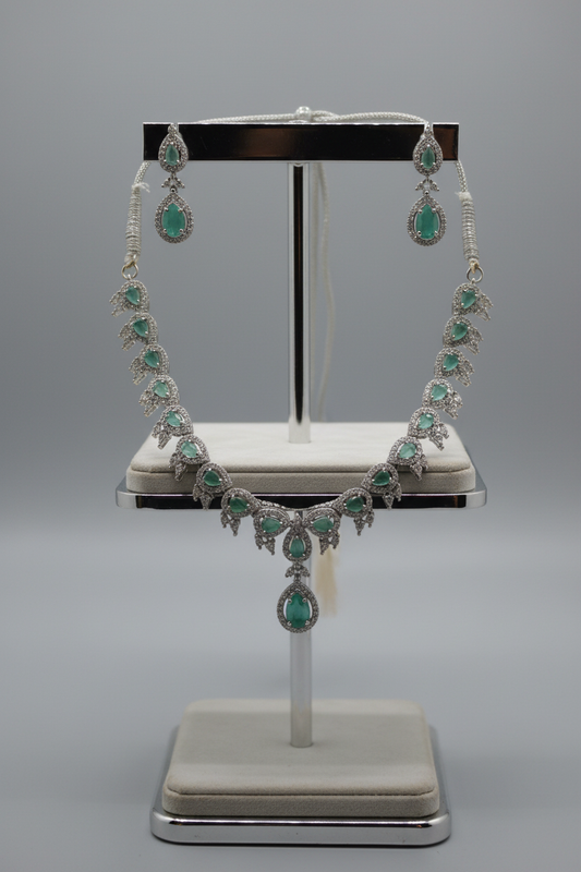 Emerald green jewellery set on display stand