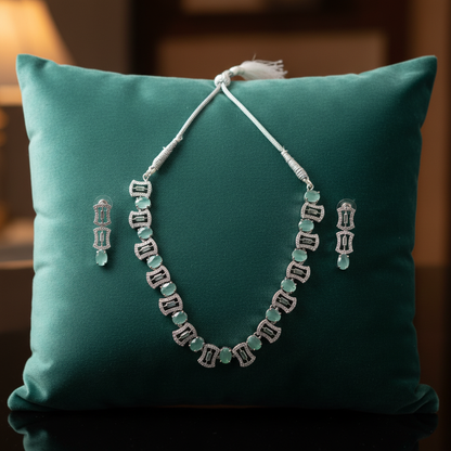 Mint green jewellery set on velvet cushion