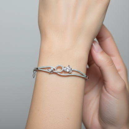 Model wearing crystal infinity bangle bracelet - close-up