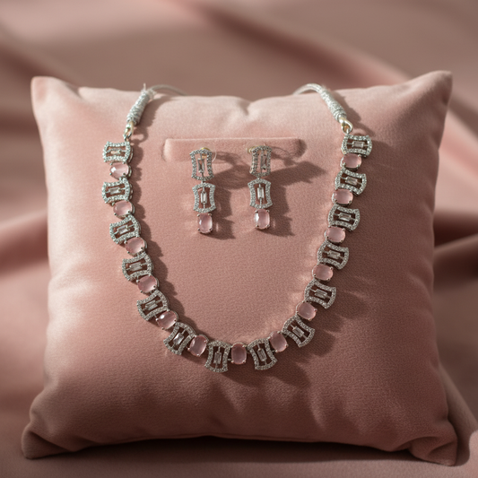 Pink gemstone jewellery set on velvet cushion