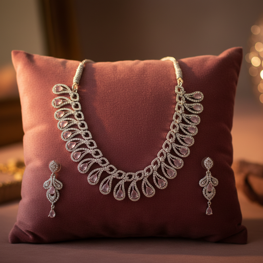 Pink gemstone teardrop jewellery set on velvet cushion