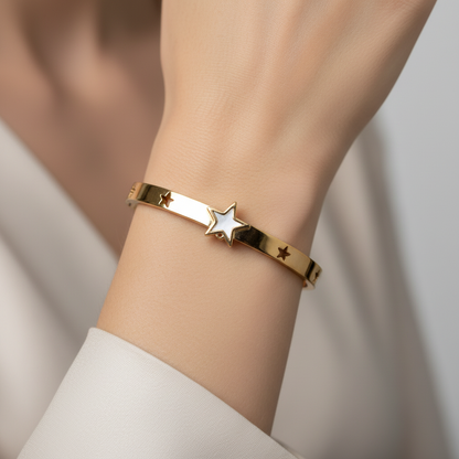 Model wearing gold star bangle bracelet - close-up
