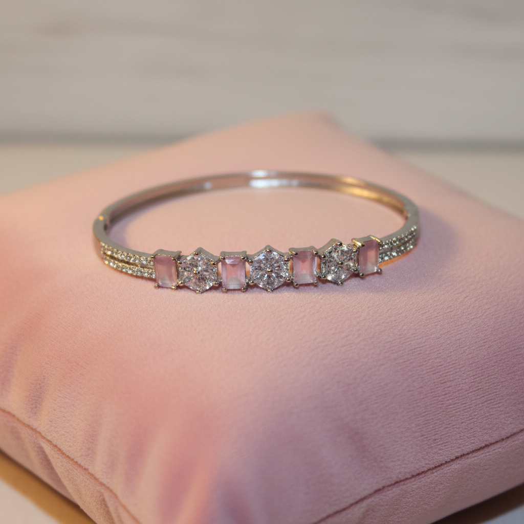 Pink gemstone bangle bracelet on velvet cushion