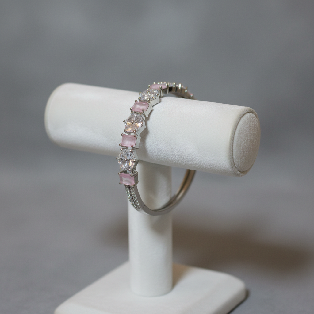 Pink gemstone bangle bracelet on display stand