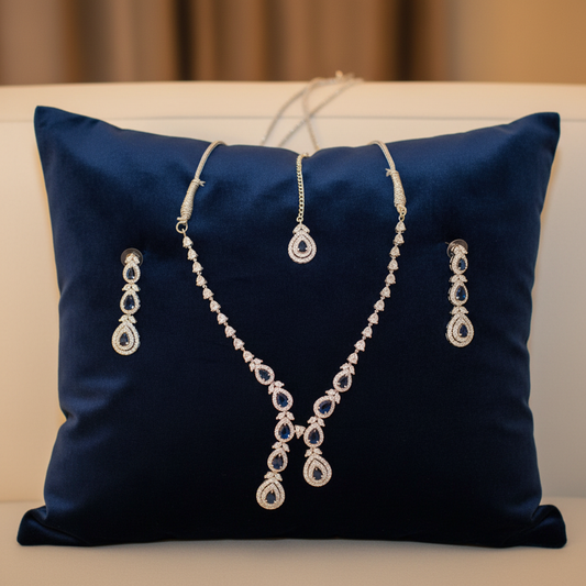 Navy blue sapphire jewellery set on velvet cushion