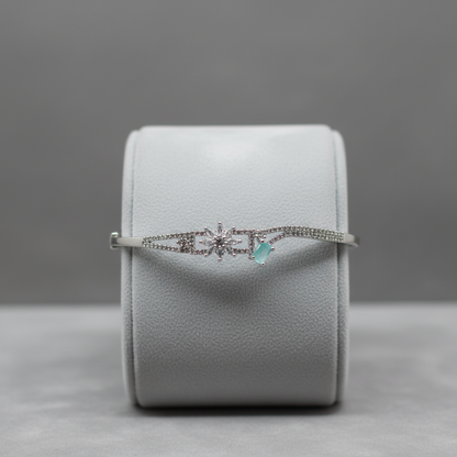 Crystal and turquoise bangle bracelet on display stand