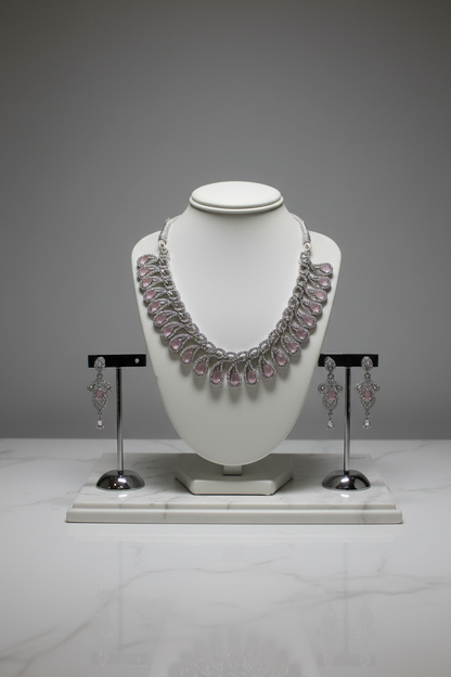 Pink gemstone teardrop jewellery set on display stand