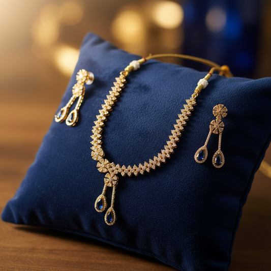 Gold and blue sapphire jewellery set on velvet cushion