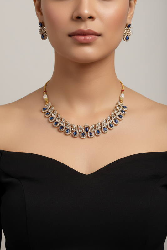 Model wearing blue sapphire and gold-tone jewellery set - close-up