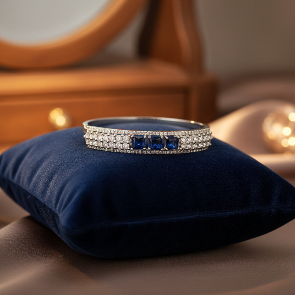 Blue sapphire bangle bracelet on velvet cushion