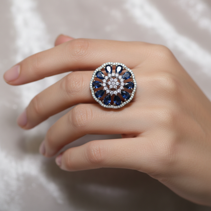 Model wearing blue sapphire and crystal flower ring - close-up