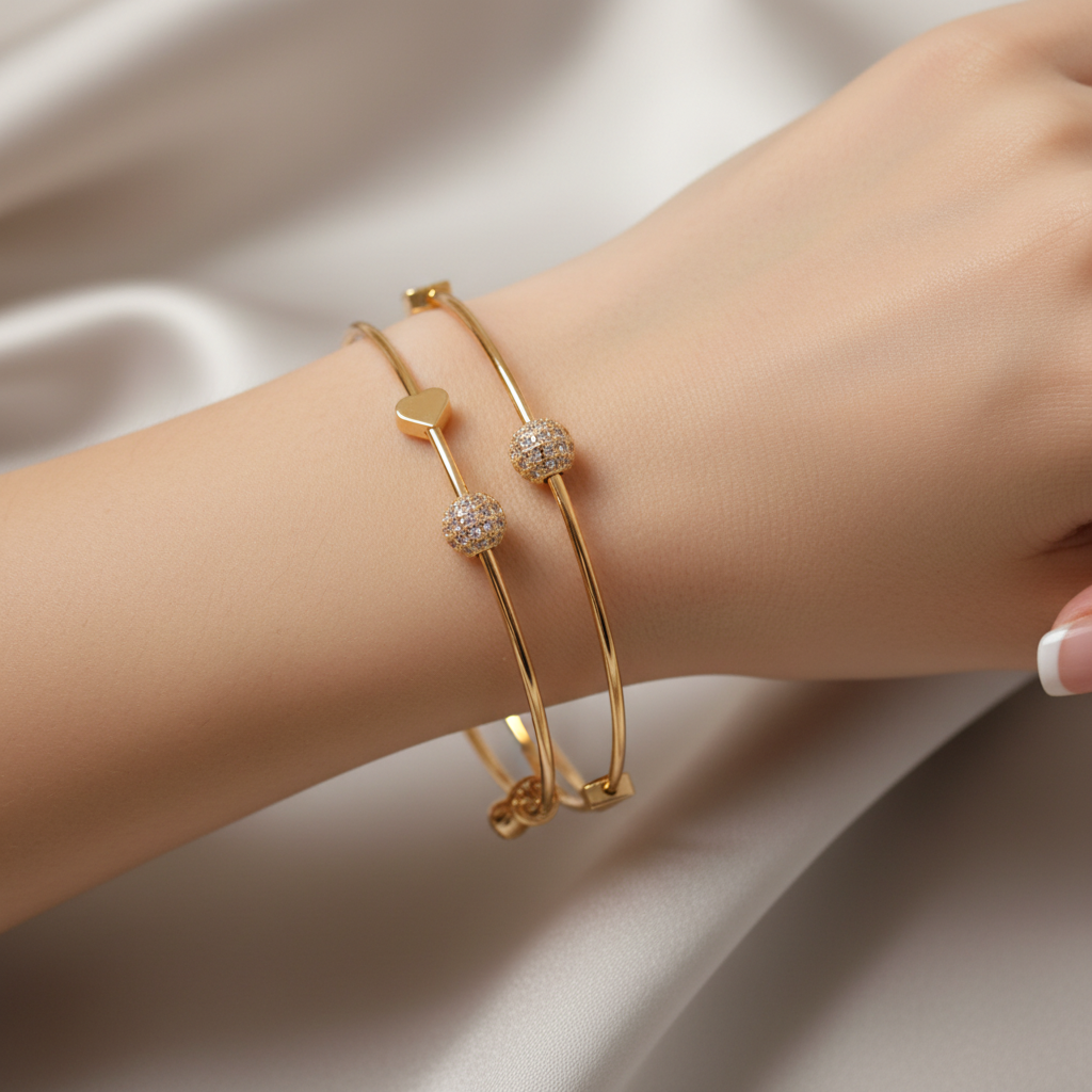 Model wearing set of 2 gold bracelets - close-up