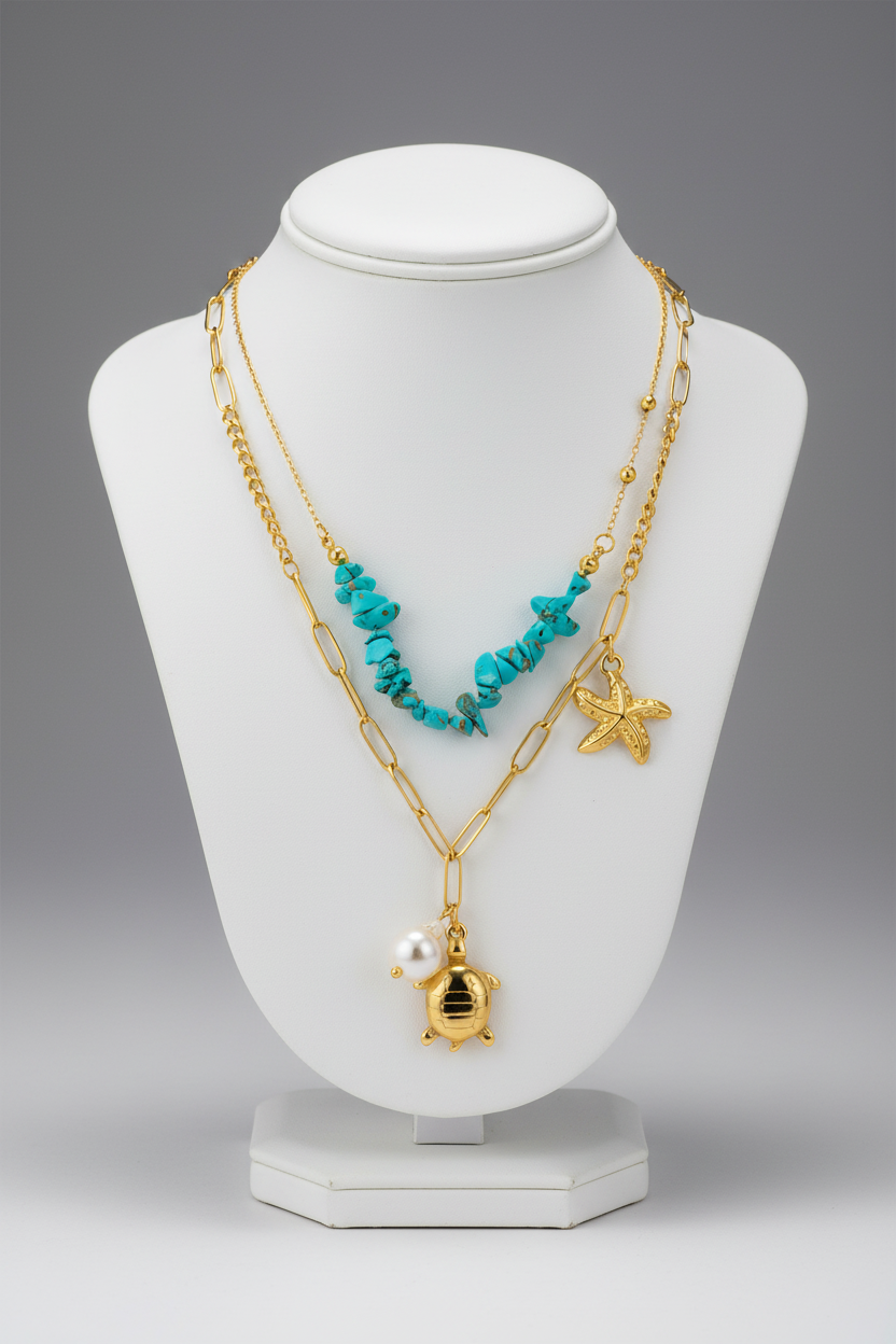 Ocean-themed layered necklace on jewellery stand